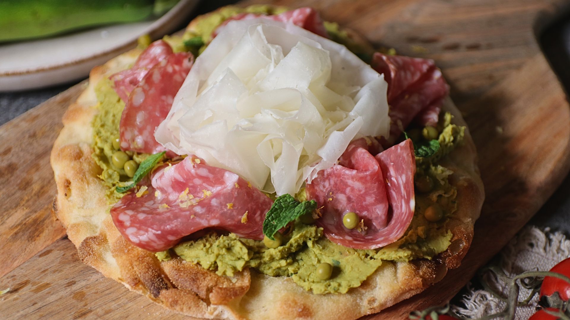Pinsa con crema di piselli, salame e Raspadura Bella Lodi